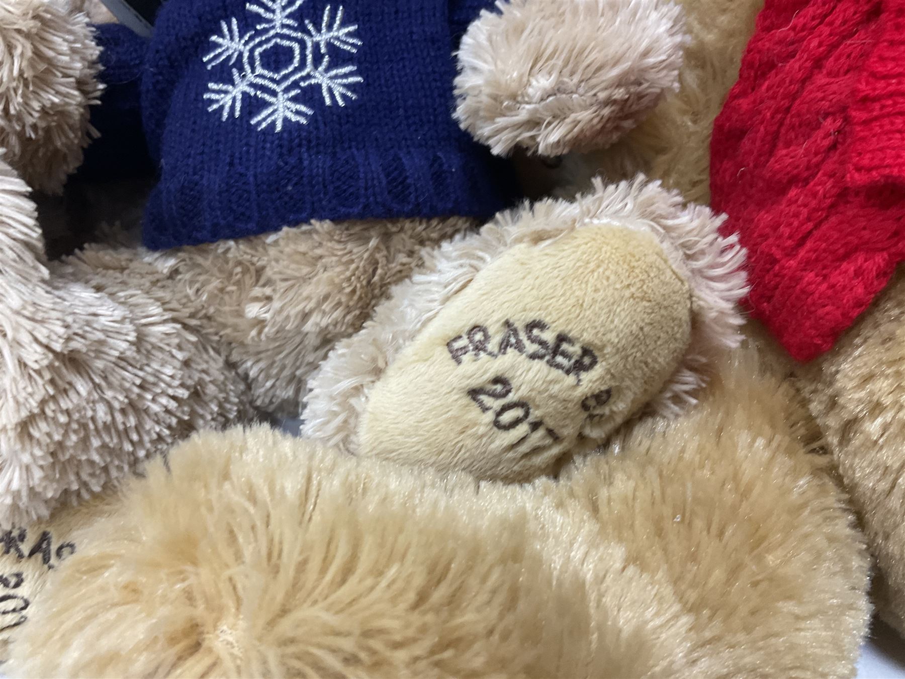 Eight annual Fraser Bears, by House of Fraser, dating between 2012 and 2019, tallest H35cm