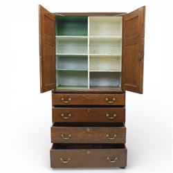 18th century oak press cupboard on chest, the moulded cornice above a pair of fielded panel doors enclosing shelved interior, the base fitted with four long graduated drawers with brass swan neck handles and shaped escutcheons, raised on bracket feet
