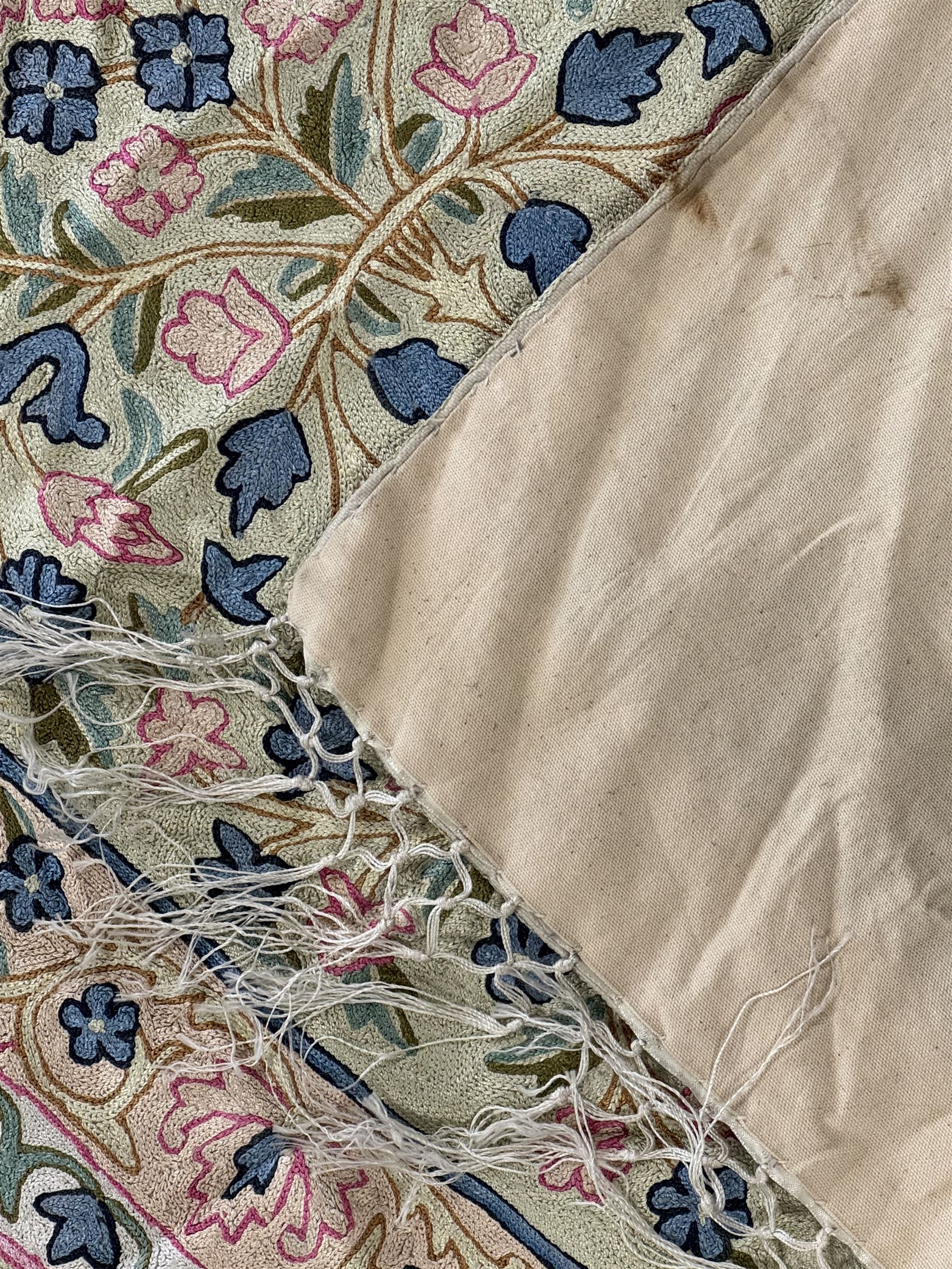 Small pastel prayer rug, cream field with Mihrab arch and trailing floral motifs in pink, blue, and green, bordered by floral patterns, knotted fringe to both ends