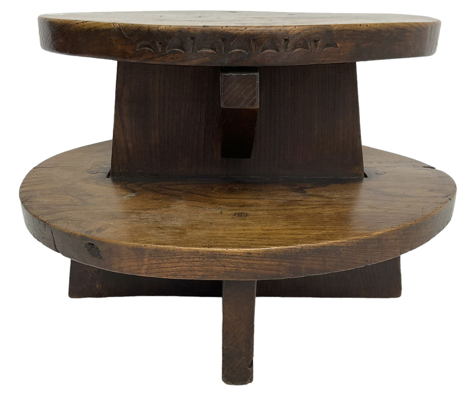 20th century figured elm occasional table, two oval tiers raised on cruciform base, the top tier carved with incised decoration 