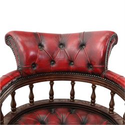 Georgian design captains swivel desk chair, rolled cresting rail over open spindle back on swivel action, upholstered in buttoned oxblood leather
