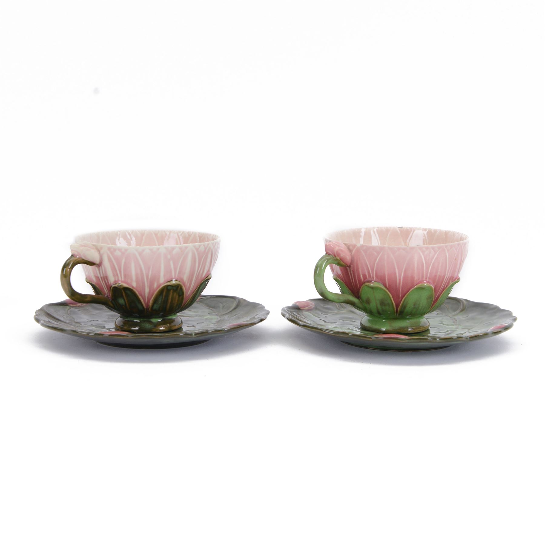 Two Zsolnay Pecs lotus moulded teacups and saucers, with impressed mark beneath