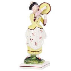 Pair of early 19th century Staffordshire pearlware figures, modelled as musicians, he playing the French horn, she the tambourine, each upon square plinth, tallest example H23cm