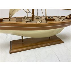 Wooden kit built model yacht with sails and mounted on wooden base, together with a small yacht model, largest example H92cm