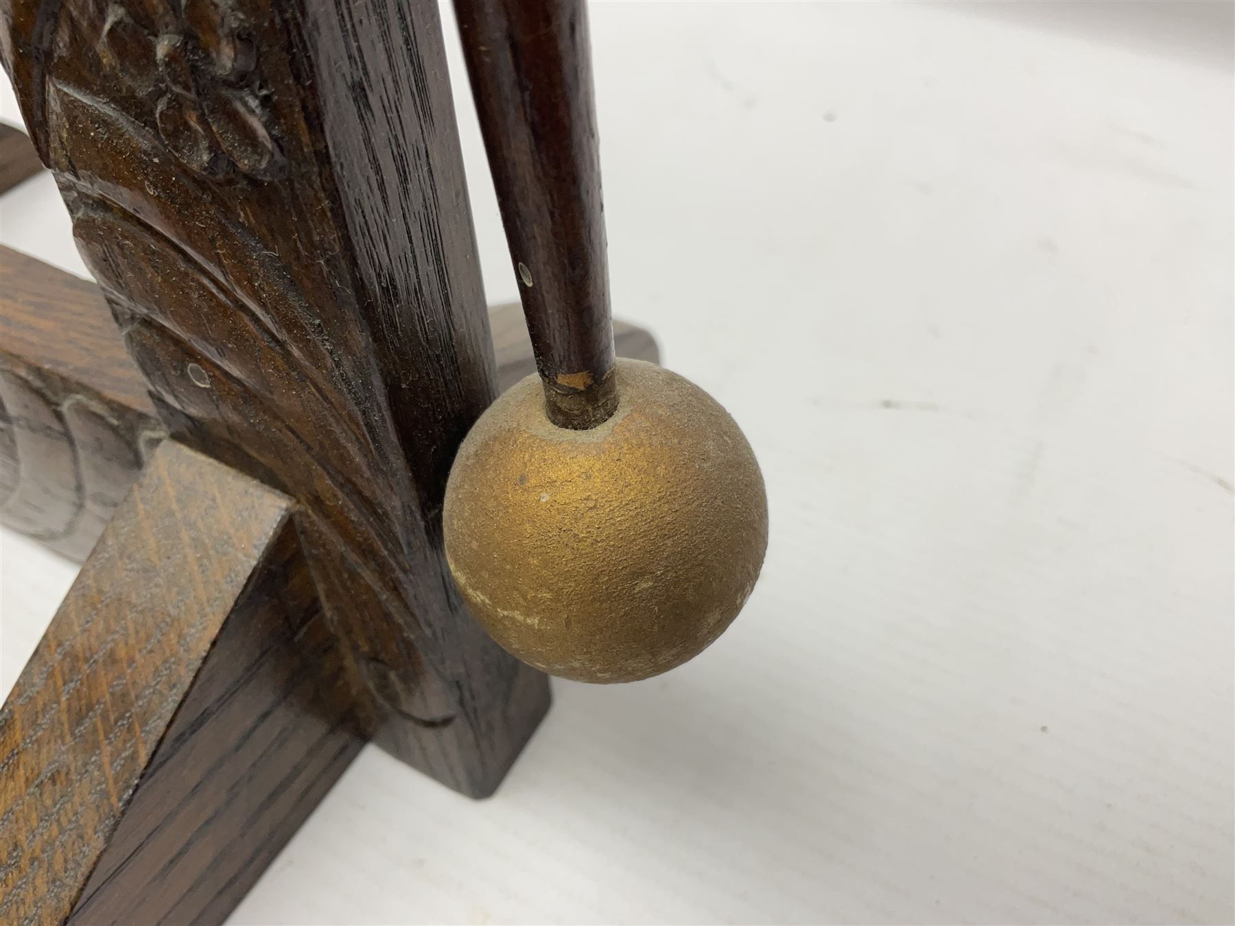 Chinese brass temple bell, decorated in high relief with a a dragon chasing a flaming pearl, within a carved floral hardwood stand, H36cm