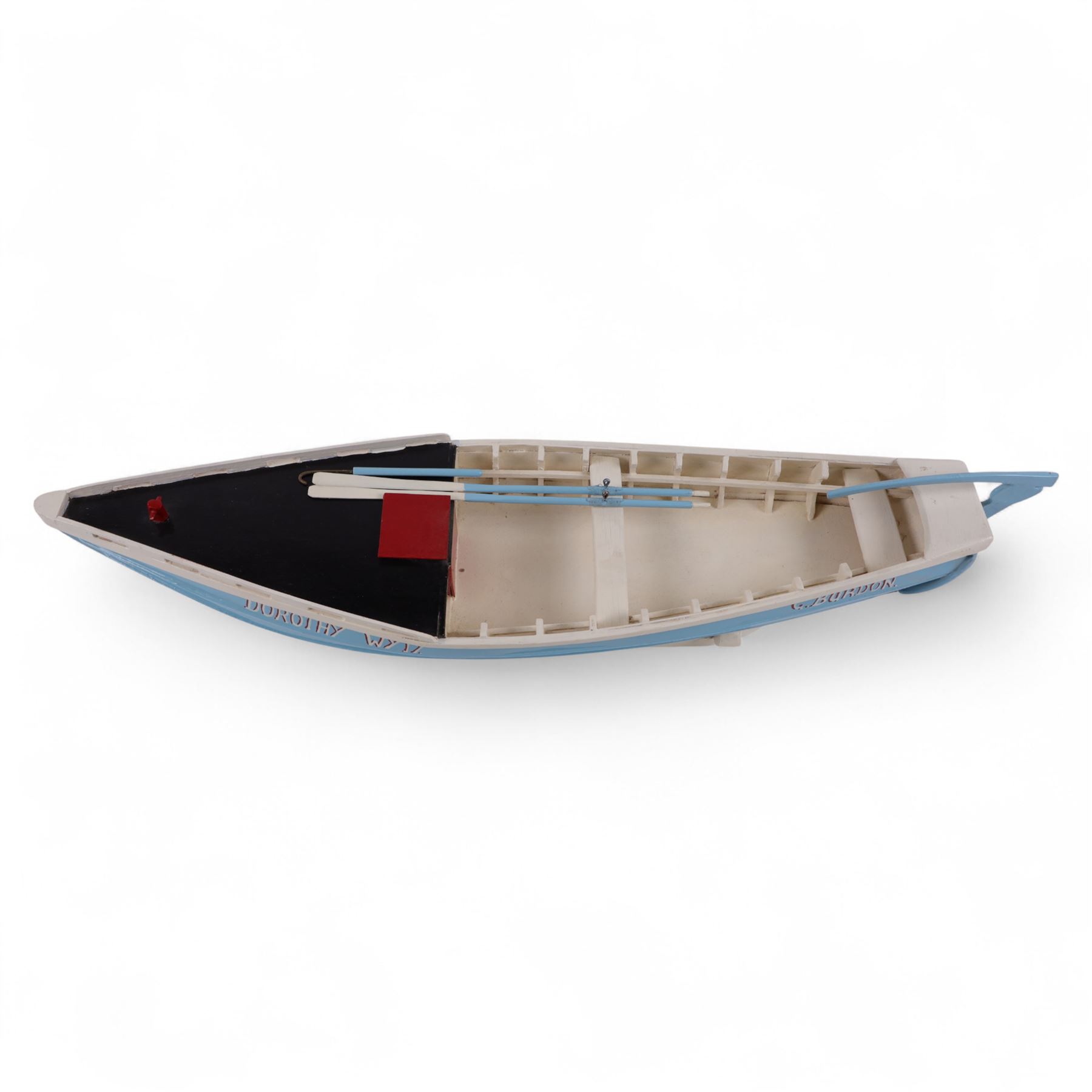 Wooden model of the Whitby fishing coble WY.17 G.Burdon 'Dorothy', painted in blue and white with red detail, with rudder and oars, on a painted wooden stand, L73cm, H20cm