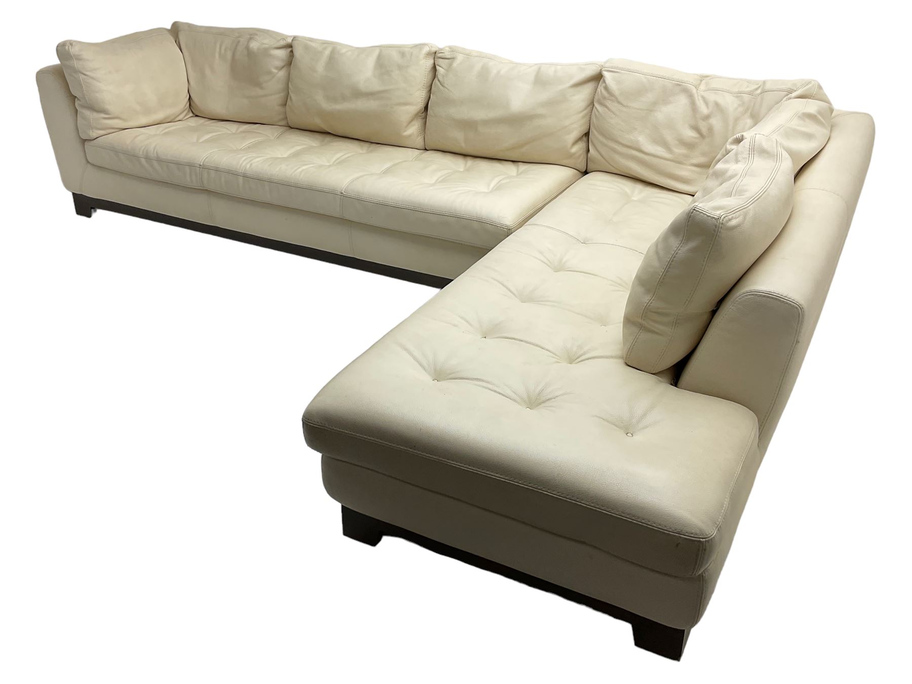 Roche-Bobois - large corner sofa, upholstered in ivory leather with buttoned seat cushions, raised on a stained beech base with bracket feet