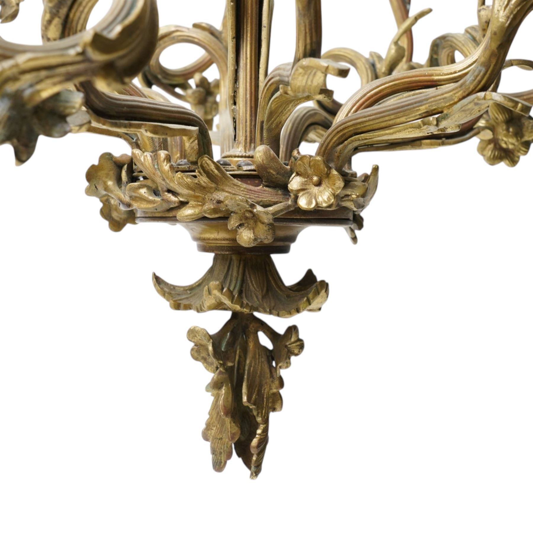 Rococo design brass ten light chandelier with scroll branches and ceramic candle holders H74cm