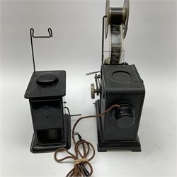 Early 20th century tinplate combined magic lantern and 35mm cinematograph projector, hand-cranked, with electric bayonet lamp, fitted with film reels, L35cm overall, and a similar projector by Gebruder Bing Nuremberg with spirit lamp (glass chimney a/f) L22cm, with two reels of film 