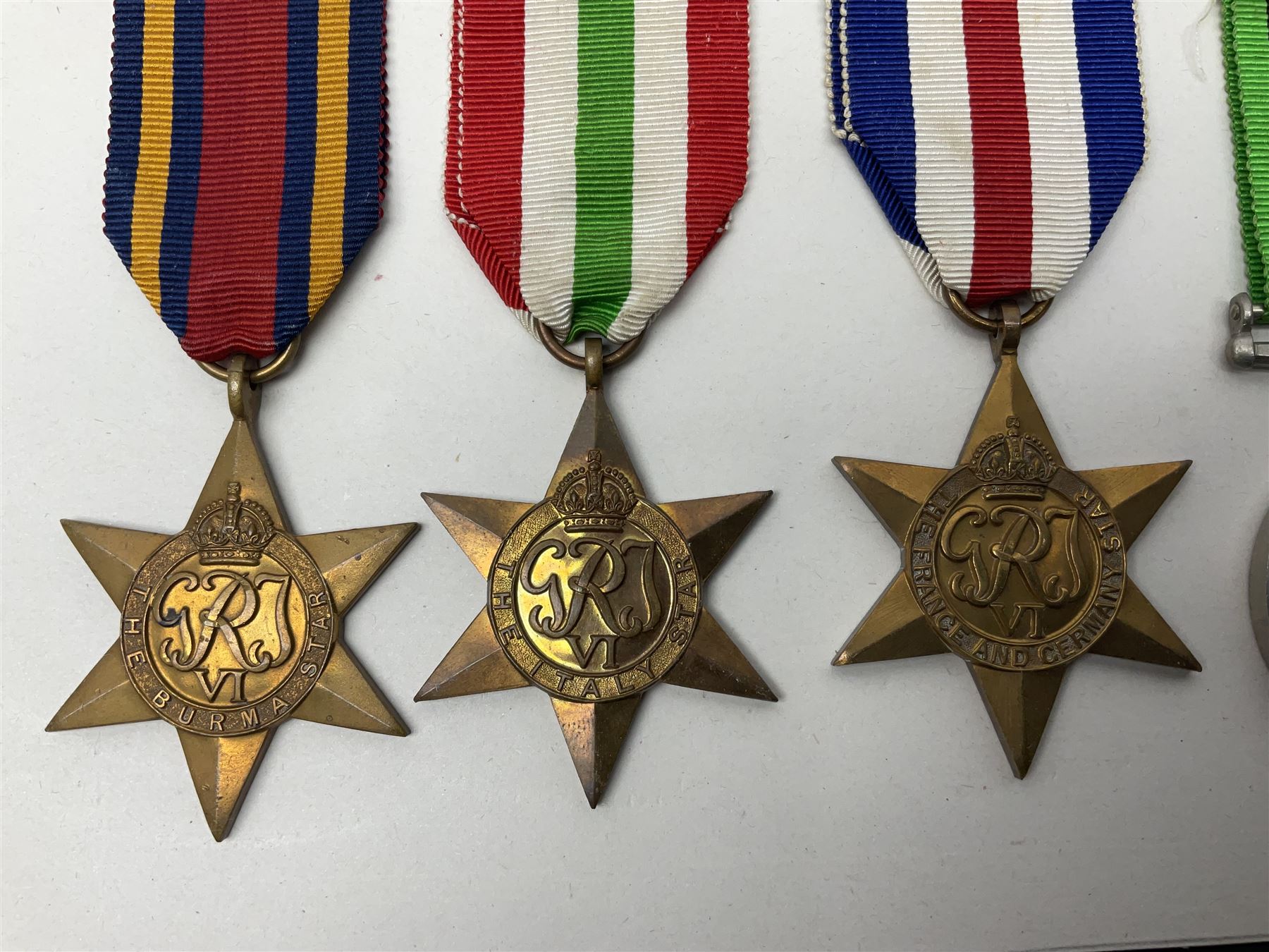 Representative display of WWII Campaign Stars and Medals comprising Burma Star, Italy Star, France & Germany Star, Defence Medal and War Medal 1939-1945; together with the corresponding group of miniatures; all with ribbons