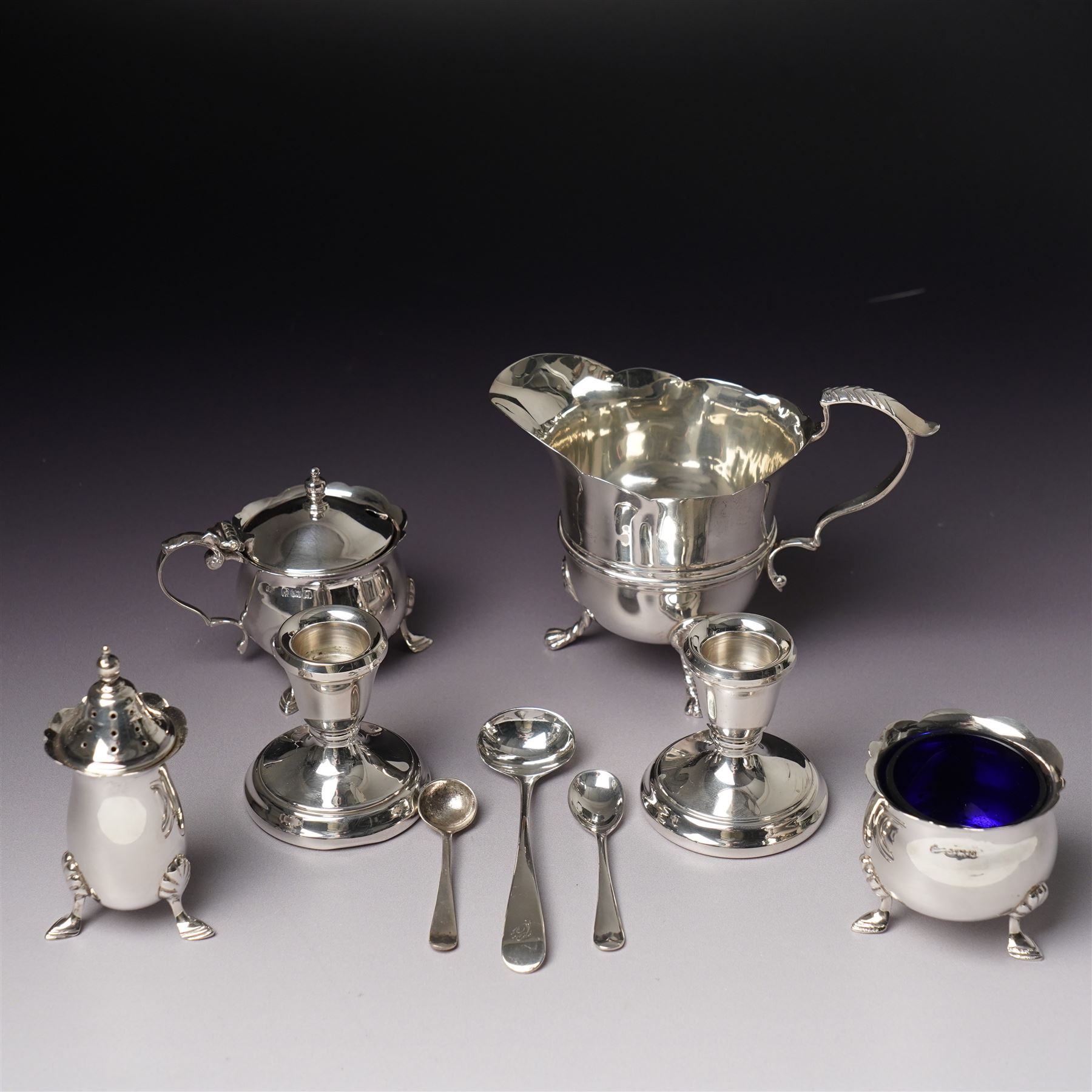 Georgian design silver cream jug Birmingham 1901 Maker George Unite, three piece silver condiment set Birmingham 1940, pair of small silver dressing table candlesticks and three condiment spoons