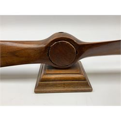 Early 20th century novelty small propeller mantle clock reputedly made by an apprentice at Blackburn Aircraft Works, Beverley & Hull in 1914, the mahogany case loosely inset with a WW1 DOXA Royal Flying Corps pocket watch, the black dial inscribed ' 30-Hour Non-Luminous Mark V.' number BE11653 with subsidiary seconds dial, the back marked with a capital 'A' above a broad arrow, mounted on a stepped square base L67cm