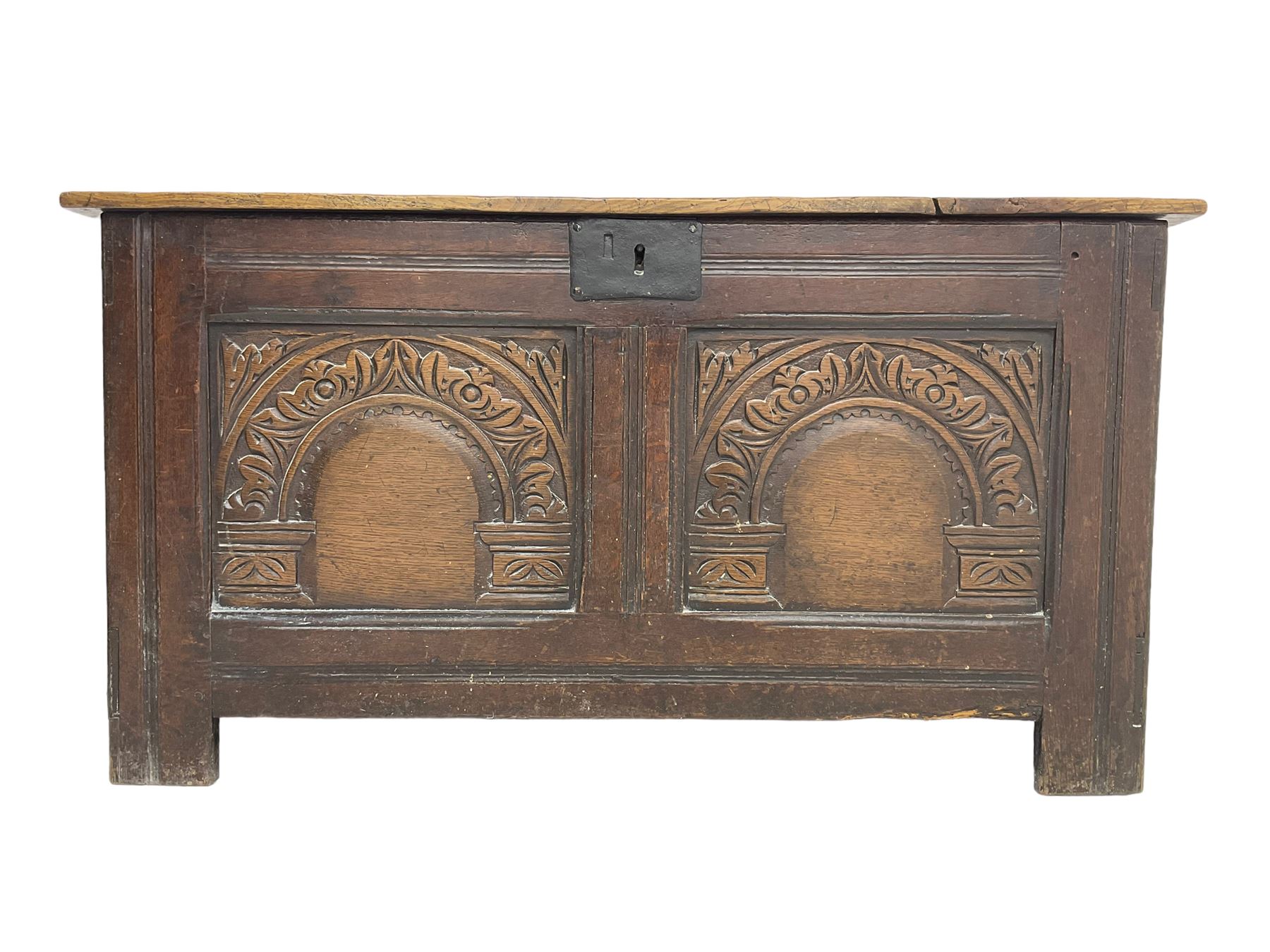 Jacobean Revival - 19th century oak blanket chest, rectangular hinged top, the two front panels carved arched foliate decoration, raised on stile supports