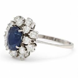 18ct white gold sapphire and diamond cluster ring, single oval cut sapphire of approx 2.10 carat, surrounded by sixteen round brilliant cut diamonds, total diamond weight approx 0.95 carat