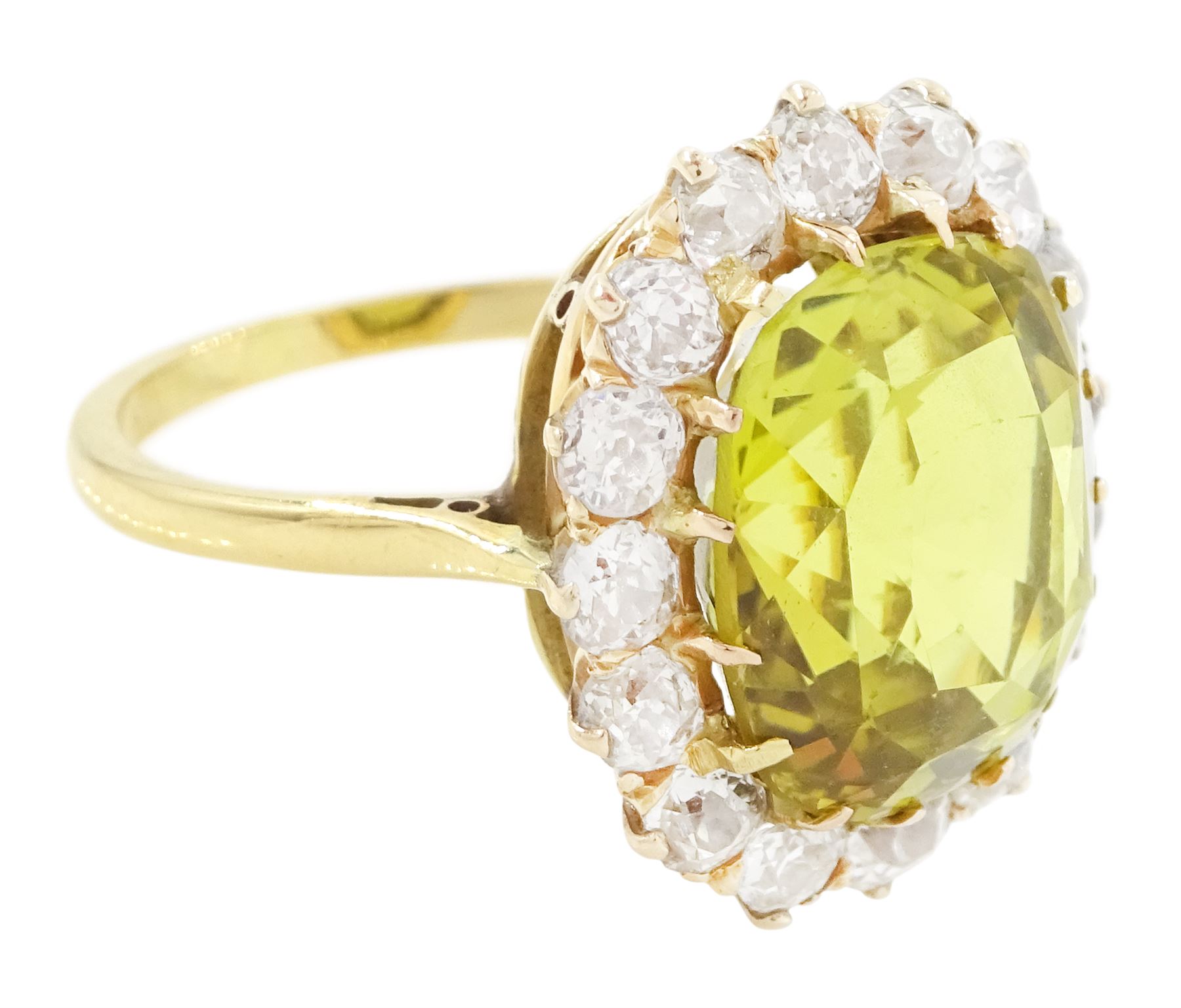 Early 20th century gold chrysoberyl and diamond cluster ring, single cushion cut yellow / green chrysoberyl of approx 8.00 carat, surrounded by sixteen old cut diamonds, stamped 18ct, total diamond weight approx 1.10 carat