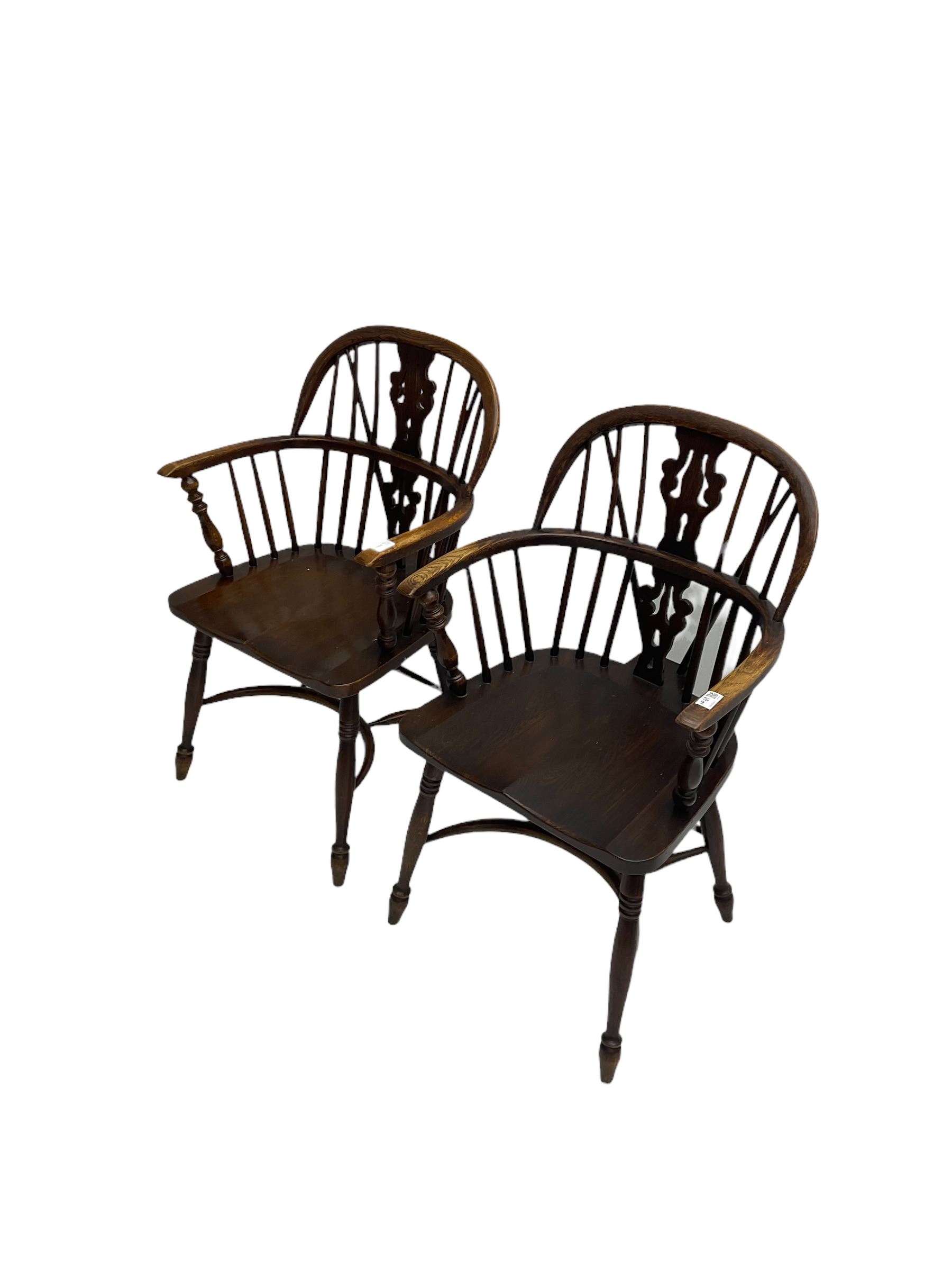 Pair late 20th century oak Windsor elbow chairs, double hoop and stick back with pierced and fretwork work splat, dished seat on turned supports joined by crinoline stretcher