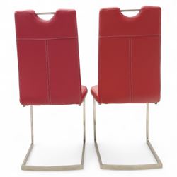 Set of seven contemporary style dining chairs, each with a high padded back and seat upholstered in faux leather on brushed steel sled bases  