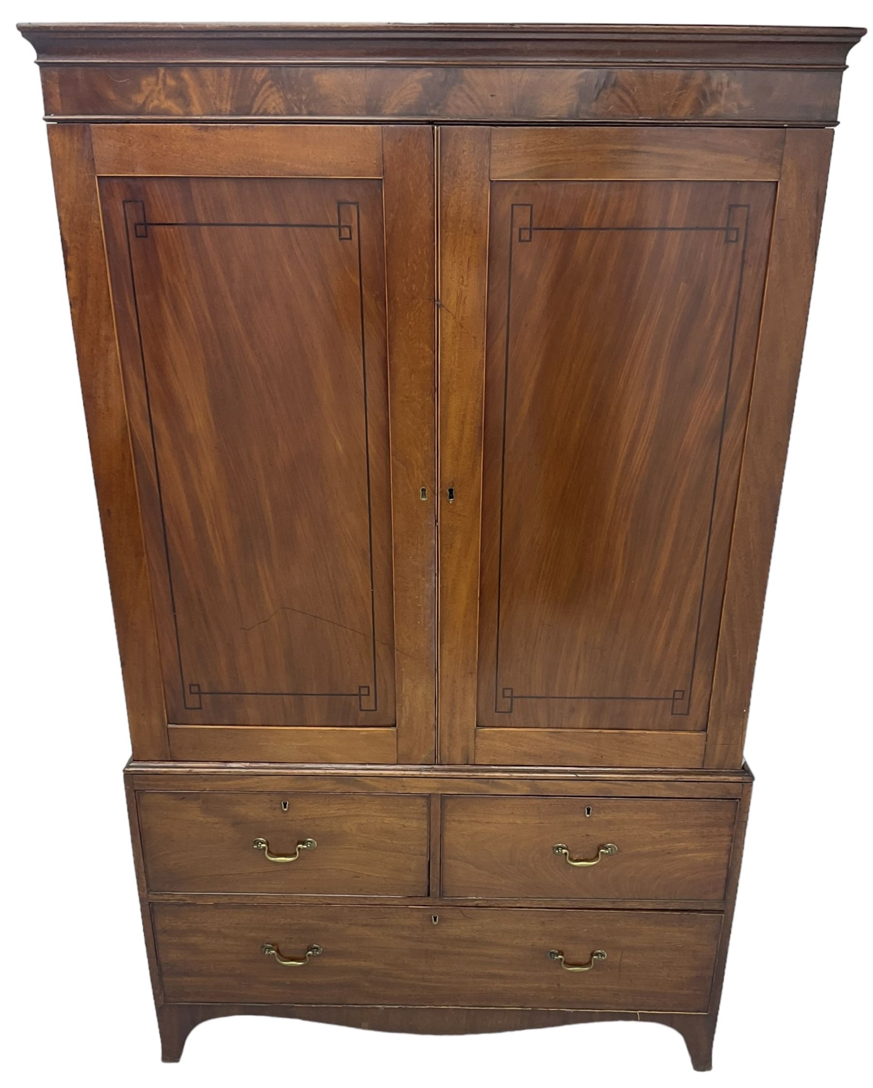 19th century mahogany linen press, projecting moulded cornice over figured frieze, enclosed by two panelled doors with geometric stringing, fitted with two short and one long cock-beaded drawers, on shaped apron and splayed bracket feet