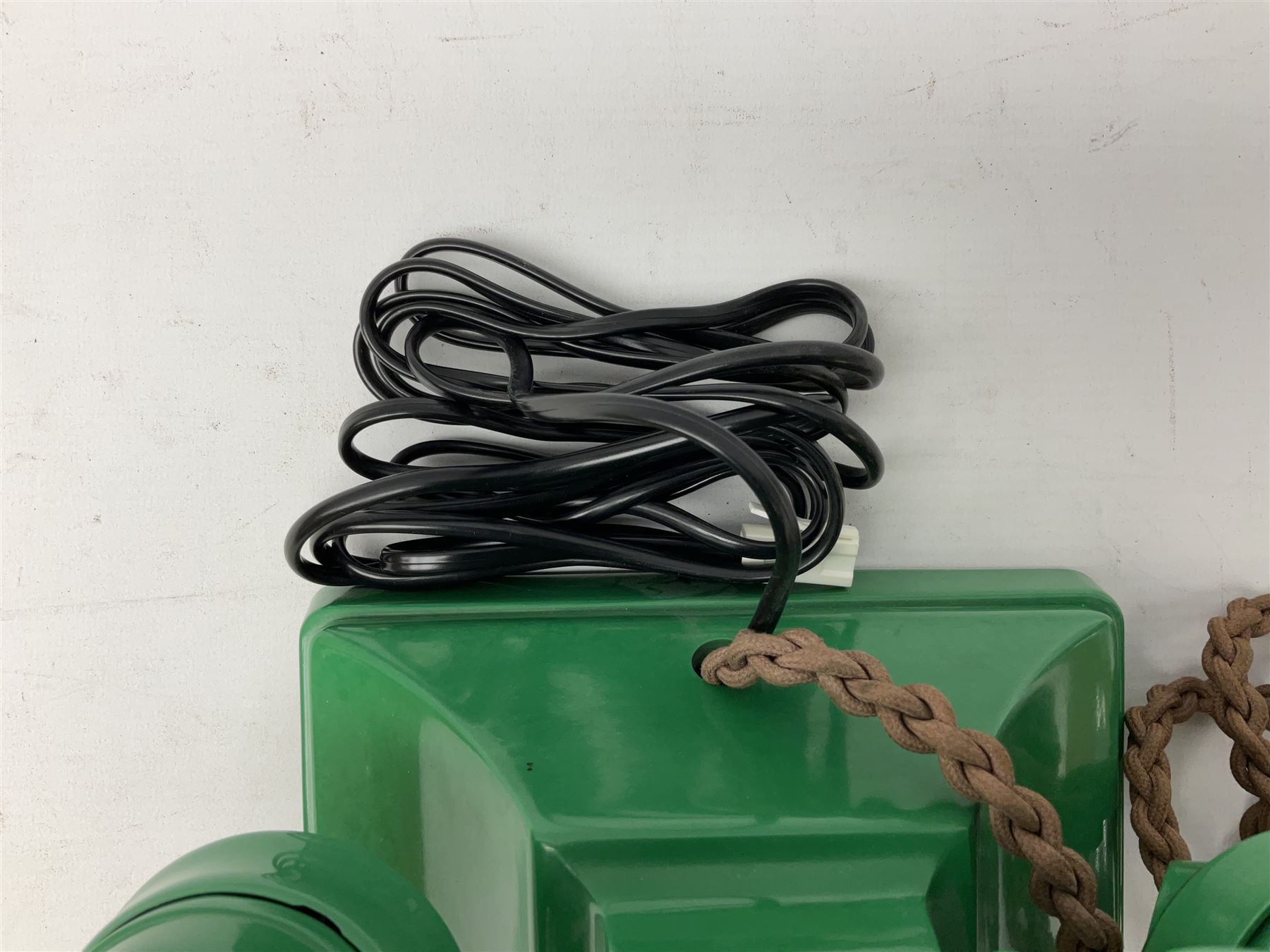 Jade green Bakelite telephone, of pyramid form with alphabet dial, brown braided handset cord and a base draw
