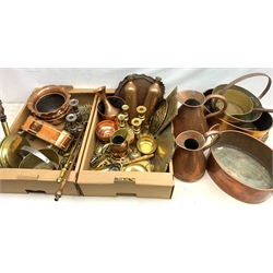  A collection of assorted copper and brass, to include an oval planter with twin lion mask carry handles, another smaller oval planter raised upon four pad feet, an oval twin handled pan, two large graduated jugs, a pair of flasks, two pairs of candlesticks, two embossed wall plaques, etc.   