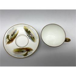 Bishop & Stonier teacup and saucer painted with mountainous lake and river scenes, with green The Staff of Hermes mark beneath, saucer D12cm