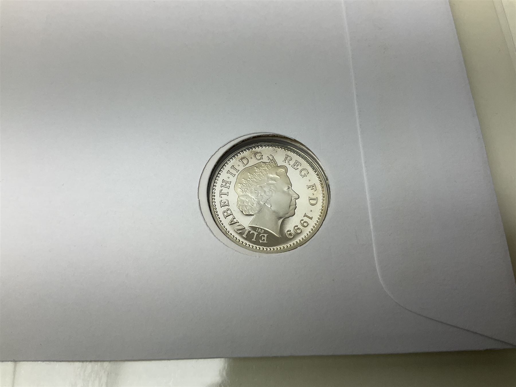 Four coin covers, comprising 2000 'The Queen Mother's 100th Birthday Silver Coin & Banknote Cover' limited edition 56/500, 2000 'Charles Darwin Commemorative Coin & Banknote Cover' limited edition 68/500, 2001 'Celebrating the 100th Birthday of Her Majesty The Queen Mother' containing  a 1999 silver one pound coin and 2001 'Royal Navy Submarines 100th Anniversary Cover' containing 2001 Turks & Caicos Islands 20 crowns silver coin