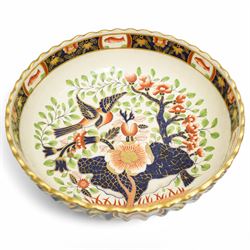 Large Victorian Copeland pedestal bowl decorated with Japanese flowers and birds, impressed mark D35cm and a Copeland two handled oval shallow dish with panels of Japanese flowers within a gilded scalloped rim, naturalistic handles and supports W30cm (2)
