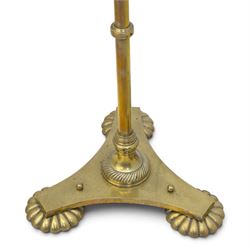 Art Deco brass standard lamp, telescopic column with level action, ring turned collars, raised on a shaped tri-form base with fluted pad feet, complete with green fabric fringed shade