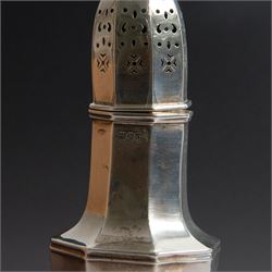 Edwardian silver sugar caster, of octagonal urn form, upon an octagonal foot, the removable pierced cover with urn finial, hallmarked Charles & George Asprey, London 1909, H21cm 