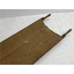 WW1 British casualty stretcher with iron mounted pitch pine sides and canvas base; stamped 'HL1917' and L7 with broad arrow in a triangle L236cm ( reputedly recovered from a barn at Bapaume on The Somme)