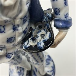 Meissen blue and white figure, modelled as a gentleman holding a hat of flowers, raised upon Greek key design base, with blue crossed swords and impressed C 73 and 149 marks beneath, H18cm