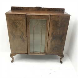 Early 20th century figured walnut side cabinet, shaped moulded top over central glazed door and two cupboards, on shell carved cabriole feet, W123cm, H126cm, D39cm