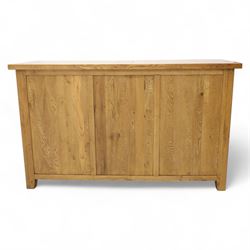 Contemporary solid oak sideboard, rectangular plank top above three drawers and three panelled cupboard doors, fitted with wooden knop handles