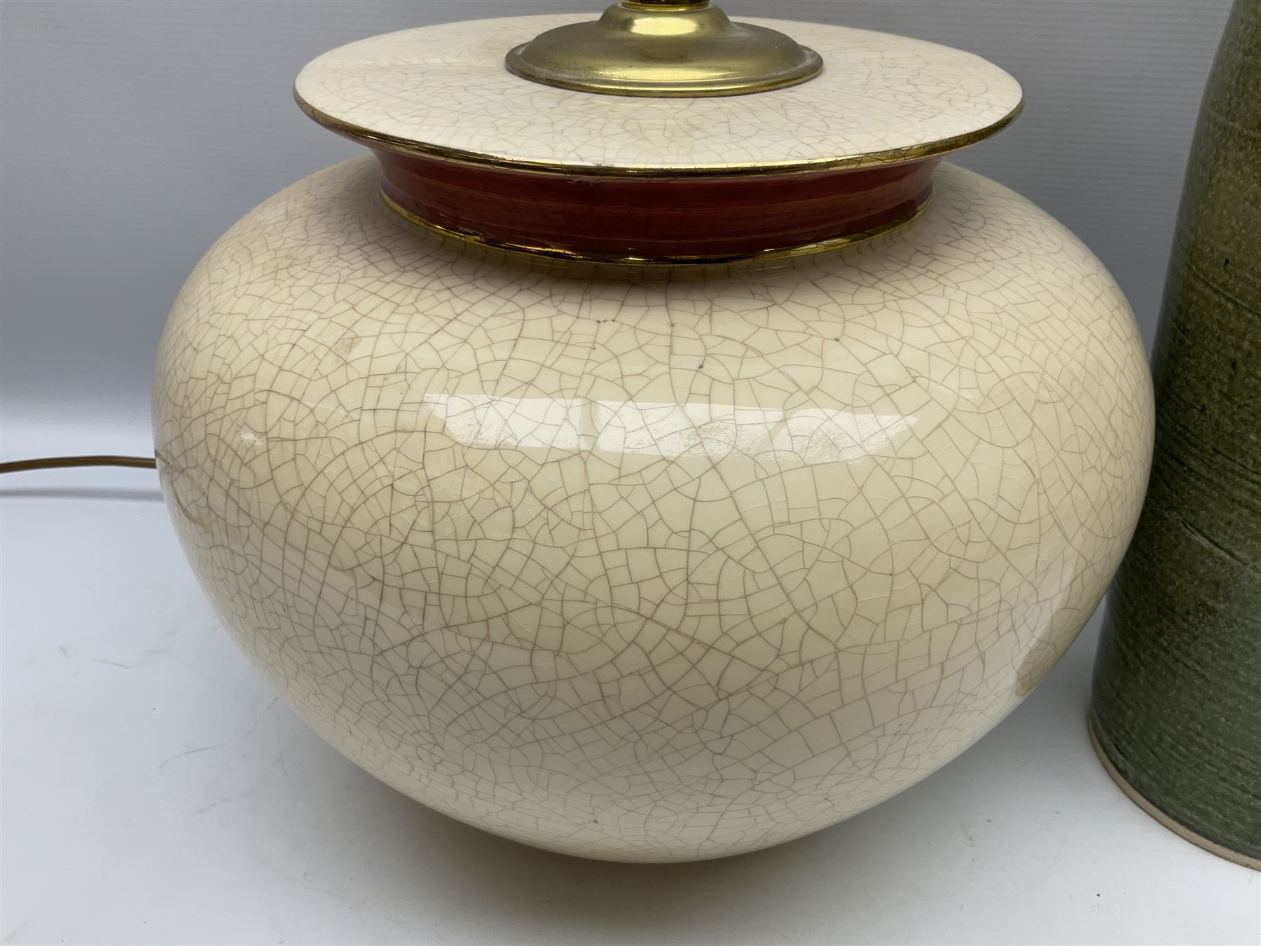Large cream crackle glaze table lamp, together with a tall studio pottery vase in green with single loop handle, with impressed makers mark, H49cm