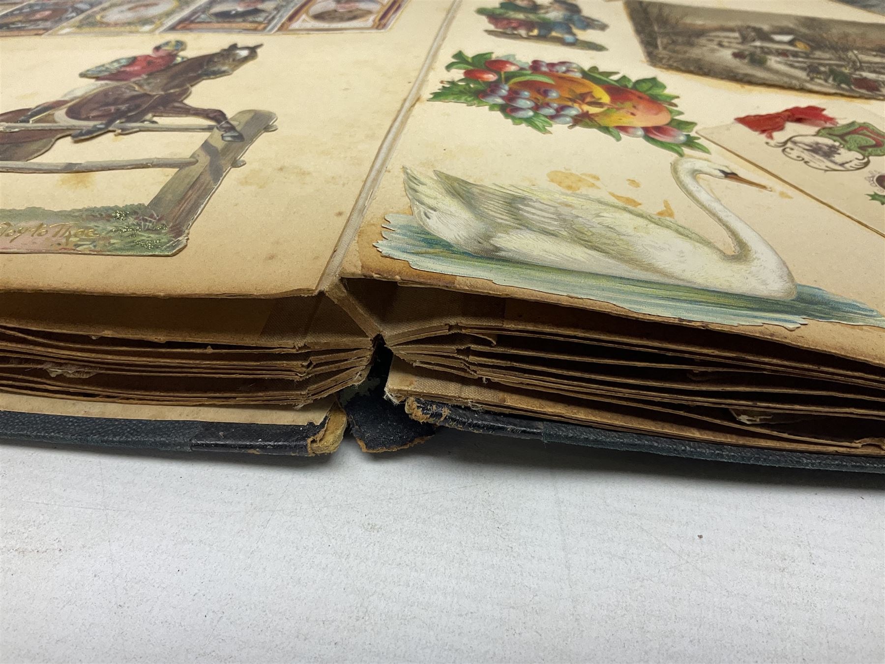 Victorian scrapbook of various fixed decoupage to include, greeting cards, portraiture, flowers, animals etc,