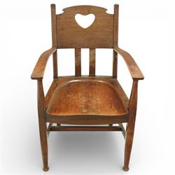Arts and Crafts oak armchair, the shaped back with heart-shaped pierced splat above three vertical slats, solid dished seat with rounded front, open arms on turned front supports, square section legs united by plain stretchers