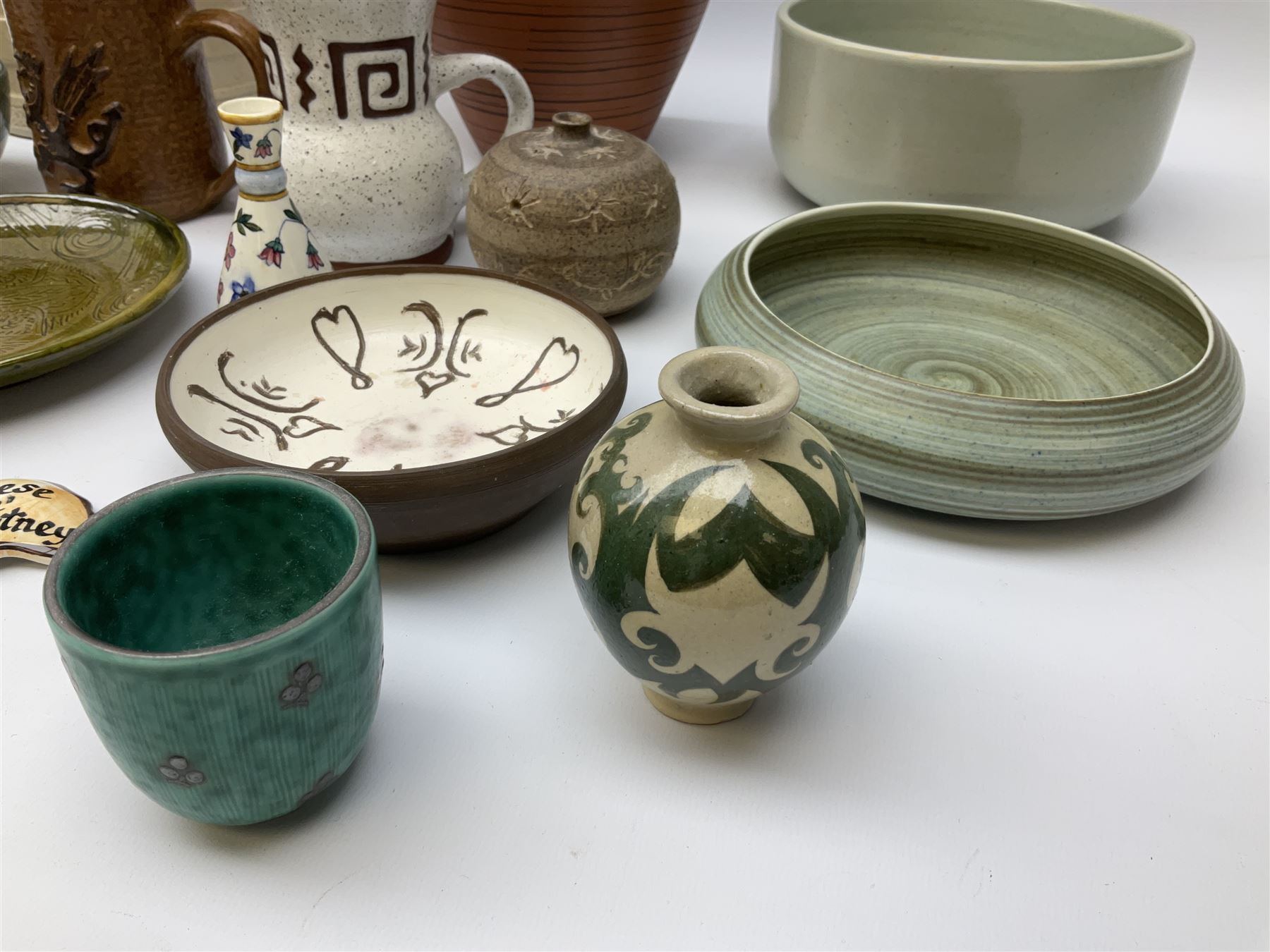 Quantity of studio pottery to include square section vase decorated with blossoming branches, other studio pottery to include jugs, bowls, vases etc, with various marks, duck egg b,J.E. bowl stamped Buchan, continental pottery, other stoneware pottery to include glazed jar with lid etc