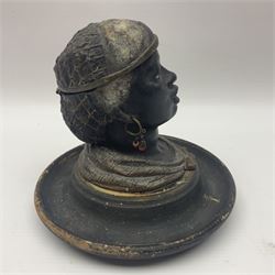 19th Century bronze figural inkwell, modelled as the head of an African-American woman with beaded hairnet and hoop earrings, her hairnet opening to reveal ink recess, the whole upon a turned circular wooden base, H14cm