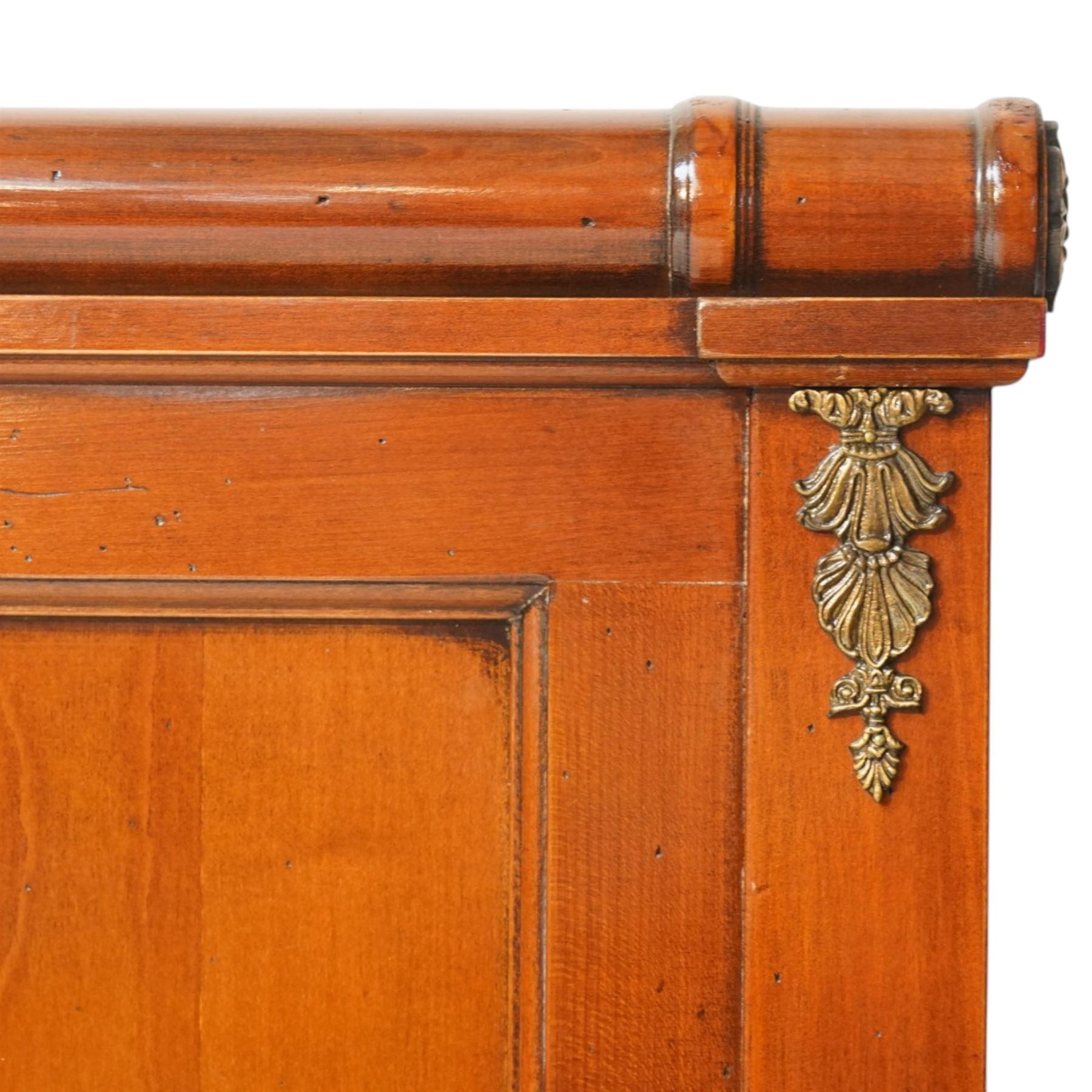 And So To Bed - cherrywood 6' super king 'Nathalie' bed, the panelled headboard and footboard with cylindrical rolled rails, decorative brass mounts to the corners, on square supports with cream and black edged fabric covered base panels 