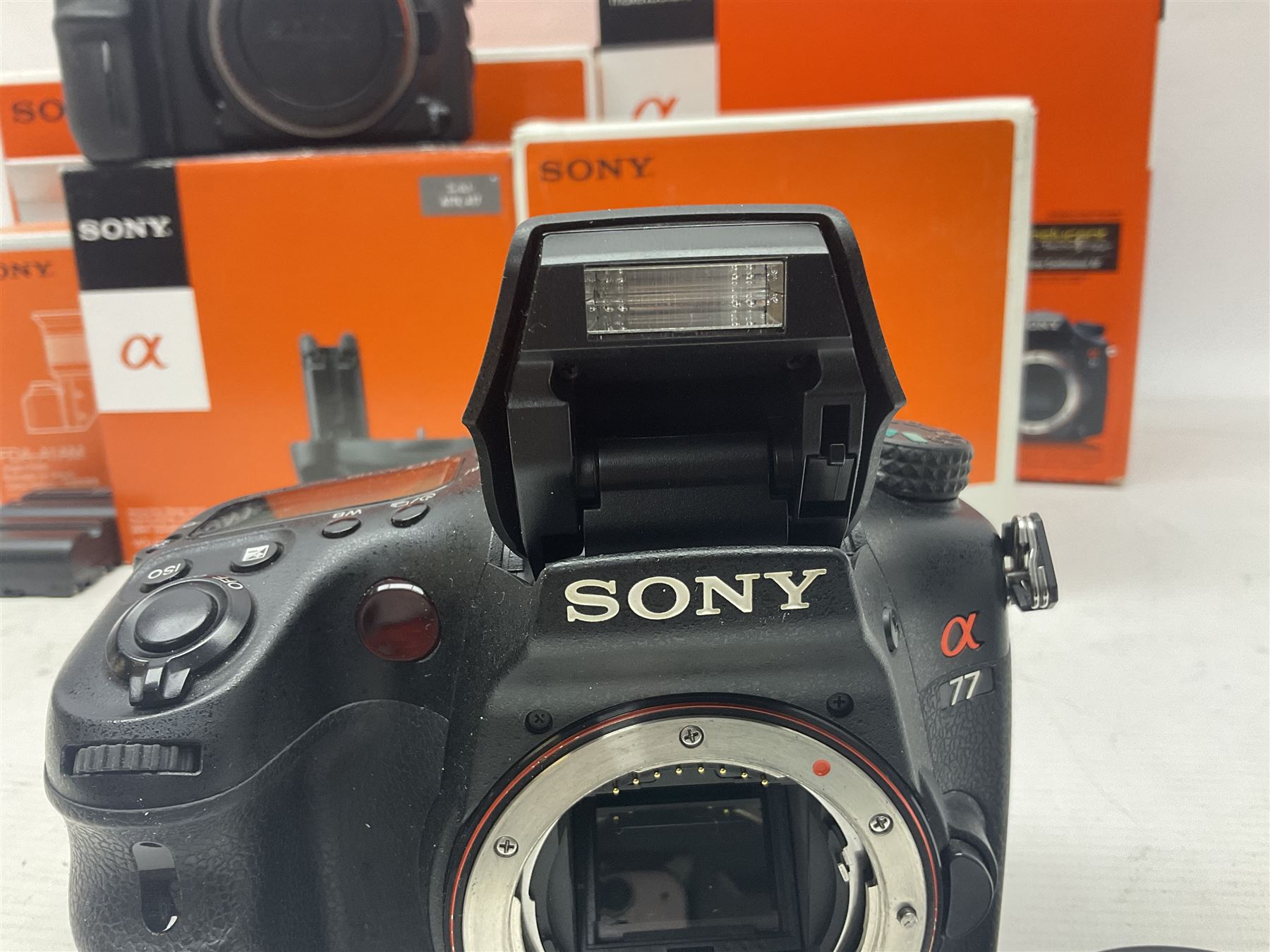 Sony Alpha A700 camera body, serial no 2340937, Sony Alpha A77 camera body, serial no 0715406, together with Sony angle finder and two firm holding grips, all with original boxes  