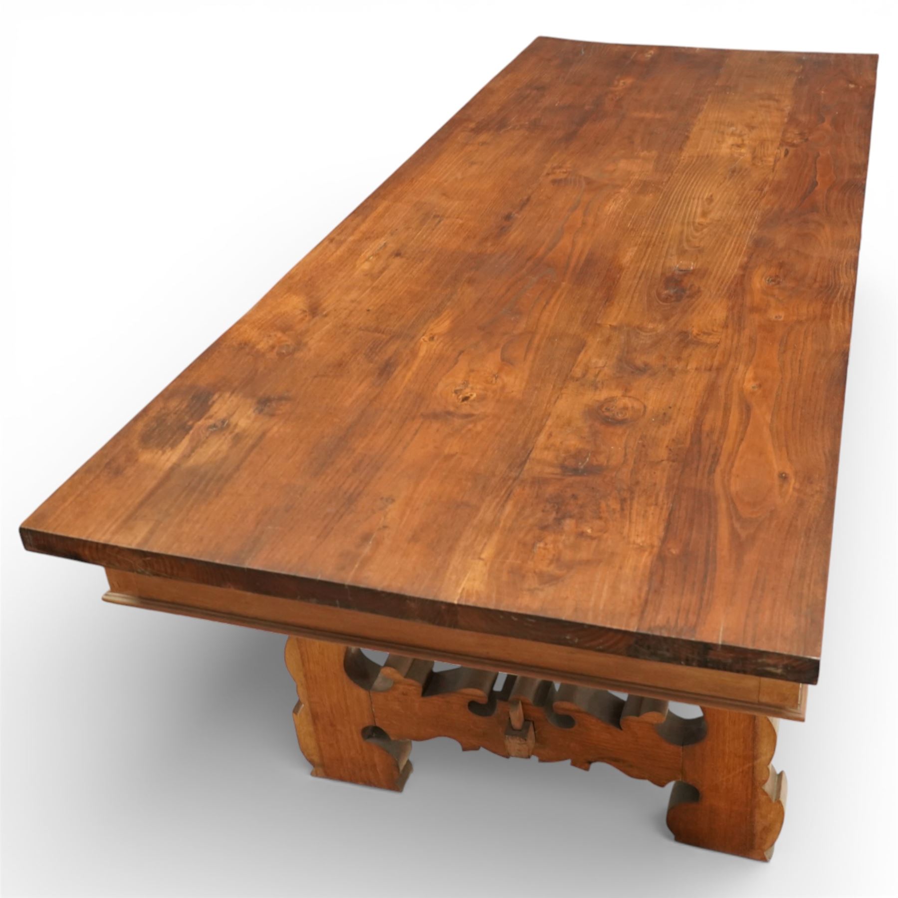 20th century Spanish design oak dining table, large rectangular top above a run of three drawers to the frieze, standing on shaped trestle supports with scroll cut details and stretcher base