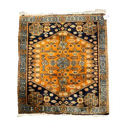 Small Persian rug/mat, blue and orange ground, decorated with stylised flower heads and geometric motifs 