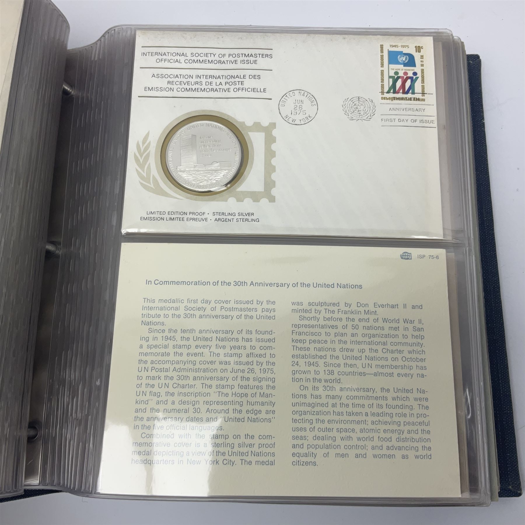 Thirty-one 'International Society of Postmasters Official Commemorative Issues' sterling silver proof medallic covers dating from 1975 to1977, housed in the official folder and a 'Commemorating The Bicentennial Of The United States Of America' sterling silver proof medallic first day cover in blue wallet