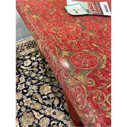 Large Knole design hardwood-framed three-seat drop-arm sofa, upholstered in crimson fabric decorated with trailing acanthus leaves and shields, together with scatter cushions 