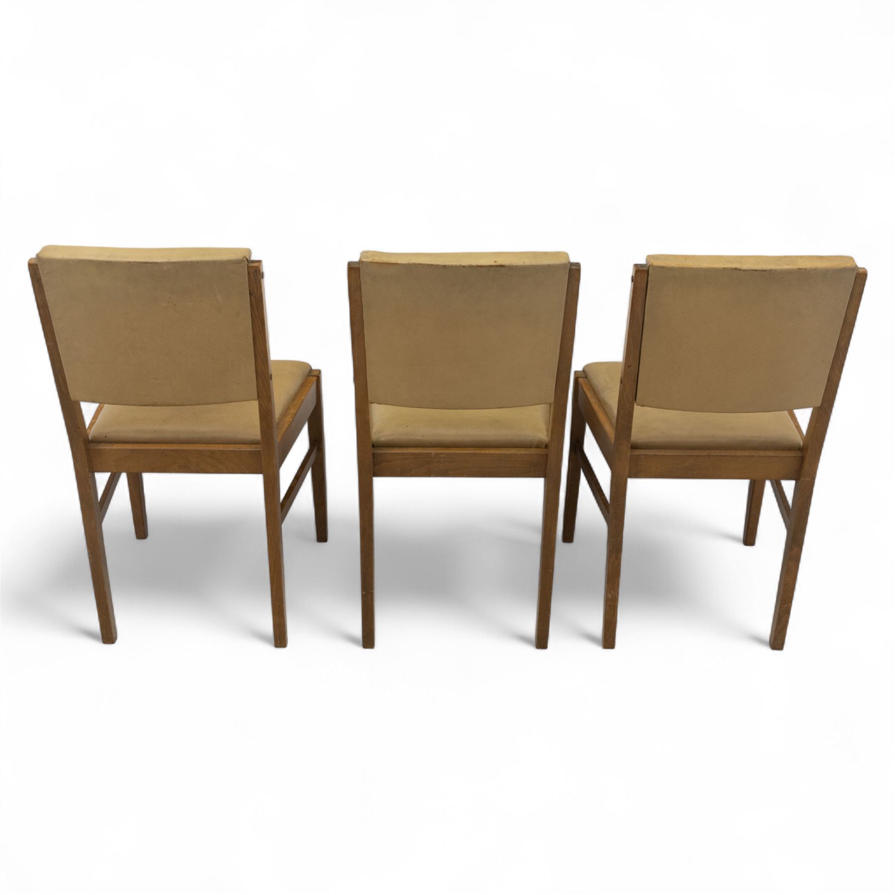 Gordon Russell - mid 20th century teak dining suite, comprising rectangular extending dining table and six matching chairs including one carver, each chair with padded upholstered seat and backrest in vinyl, on square supports, the table with plain top and rounded edges on tapered legs, an example of the firm’s functional post-war design with restrained modernist detailing (Chairs H 85cm, W 47cm, D 46cm) (Extends to 154cm)