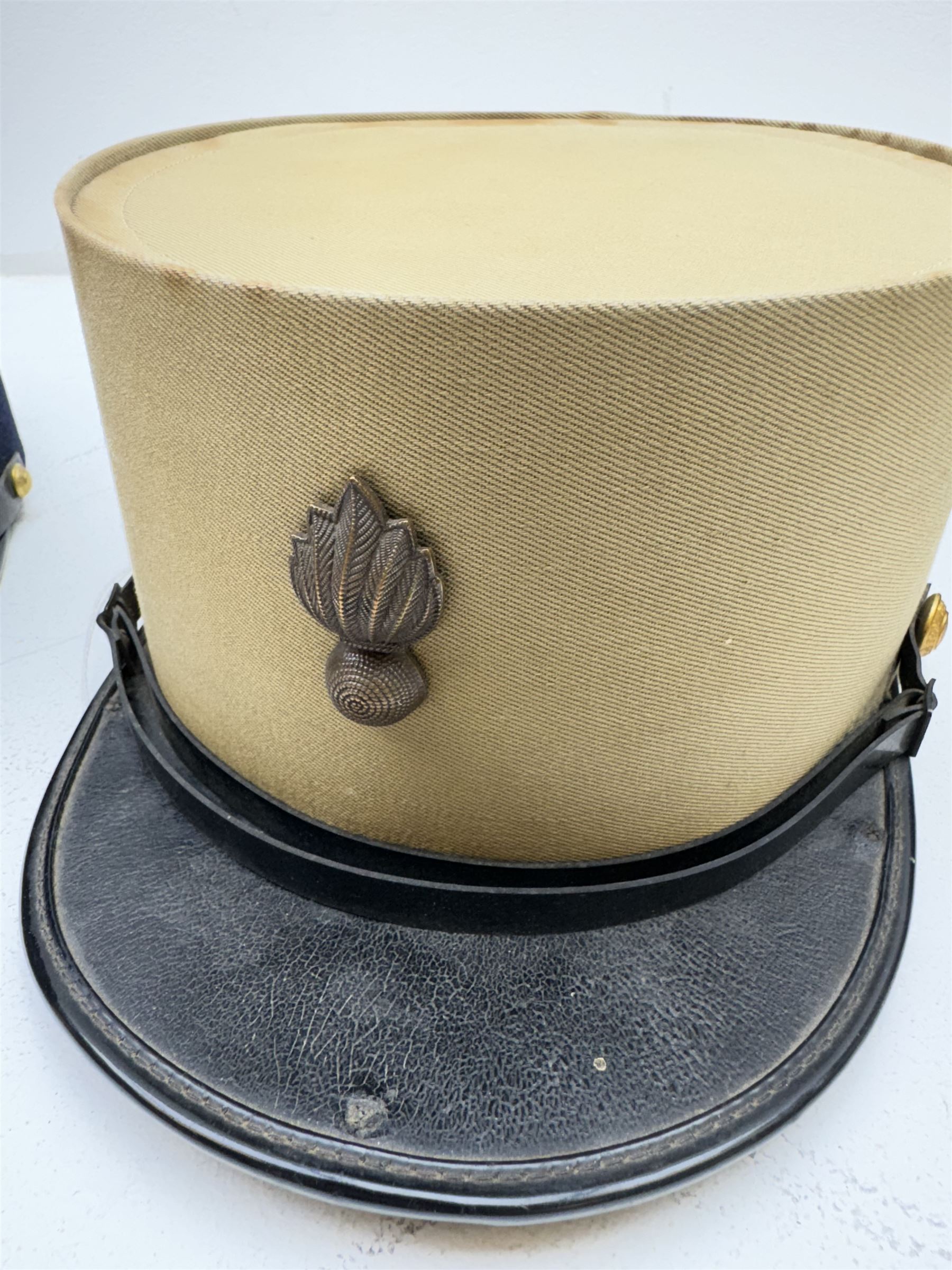 Three French Foreign Legion Kepis; two infantry examples and the third Calvary, each with black peak, original leather sweatband and markers mark stamped inside 