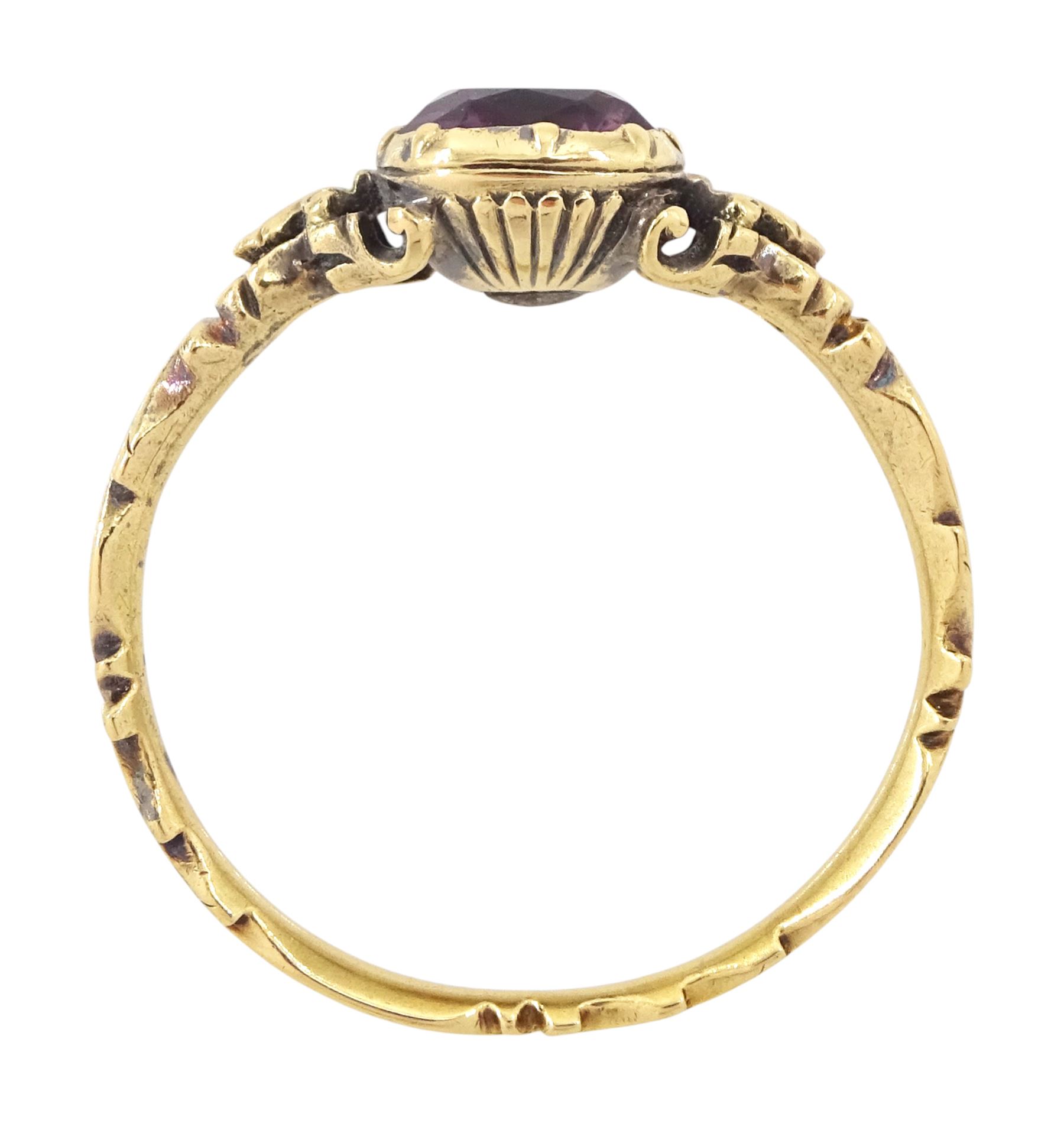 George II 18ct gold amethyst and enamel mourning ring, single cushion cut amethyst, with foiled and glazed back, to pierced fleur-de-lis shoulders, the white enamelled shank engraved Grace Hutchinson OB: 13 Dec: 1756