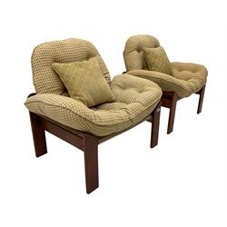 A pair of mid-20th century stained teak framed slung seat chairs, loose buttoned cushions