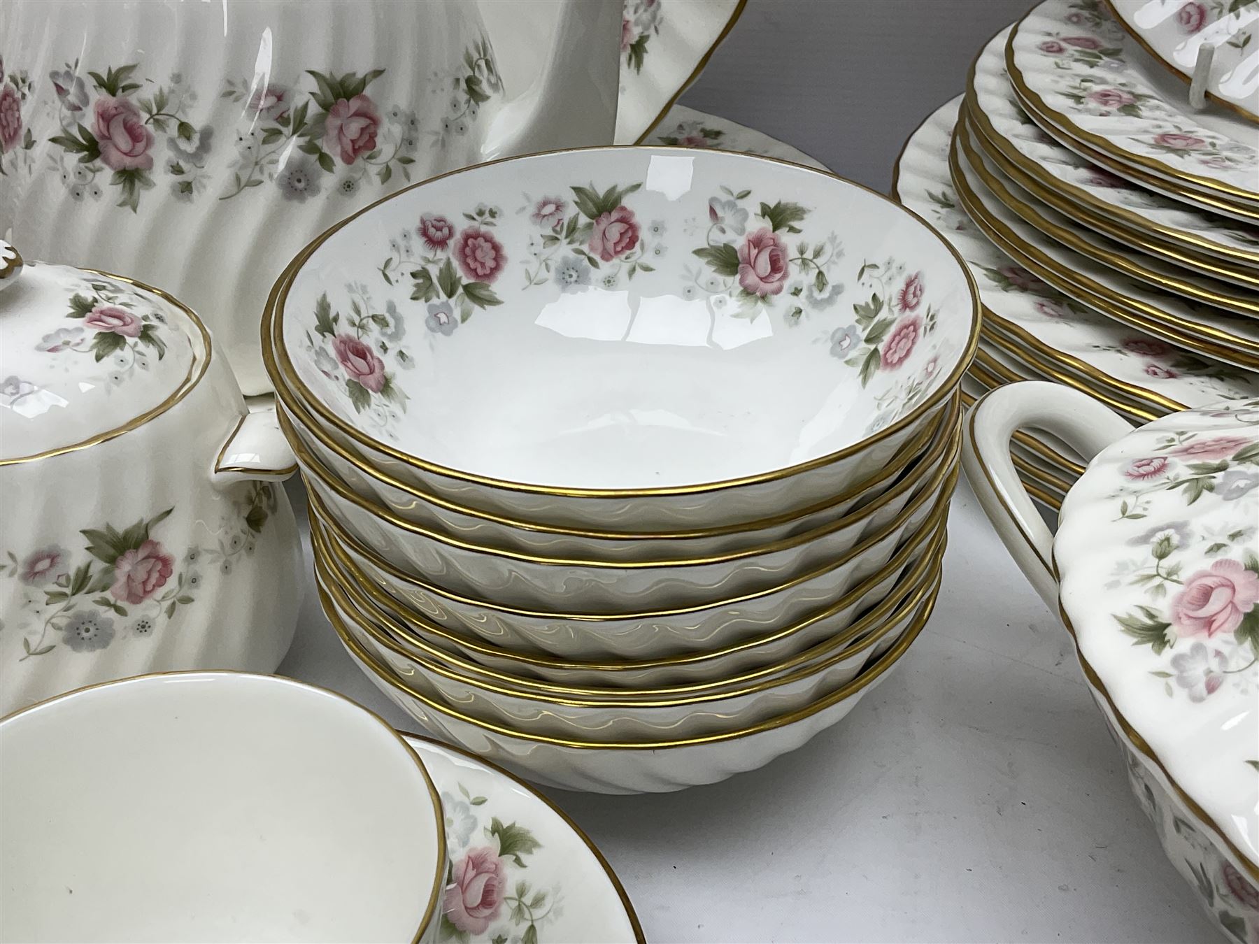 Minton Spring Bouquet pattern dinner and tea service, comprising dinner plates, twin handled tureens with covers, meat platter, teapot, milk jug, sugar bowl with cover, tea cups and saucers, bowls, cake plate, side plates, dessert plates, etc all with printed mark beneath (82)