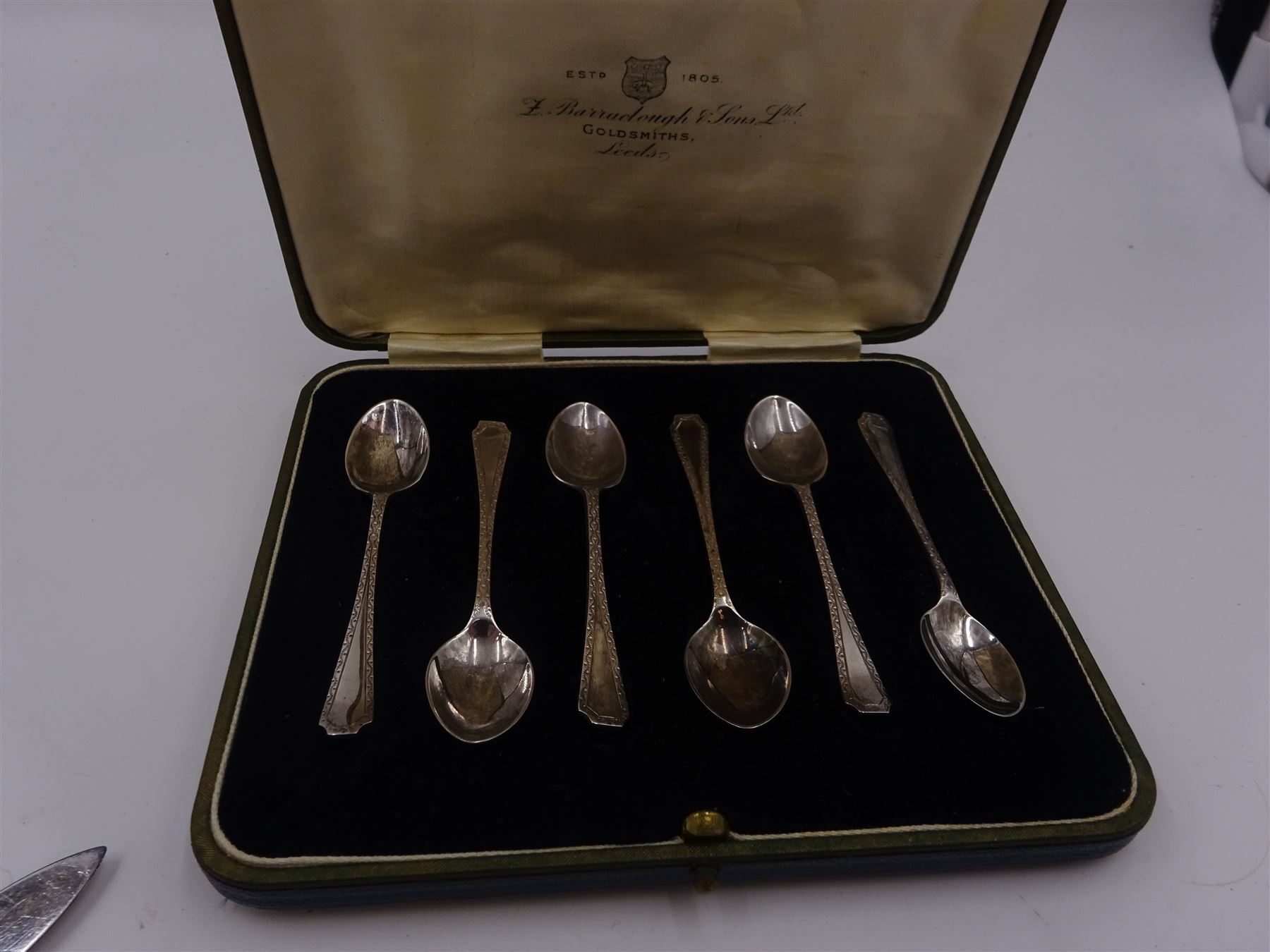 Set of 1930s silver handled fruit knives and forks, for six place settings, the handles decorated in relief with fruiting vines, hallmarked Walker & Hall, Sheffield 1934, together with a set of six 1920s silver egg spoons, with pin prick engraving to handle, hallmarked Thomas Bradbury & Sons Ltd, Sheffield 1929, in fitted case, three silver napkin rings, to include a pair, of octagonal form, with floral engraving, hallmarked John Rose, Birmingham 1951 and two silver souvenir spoons